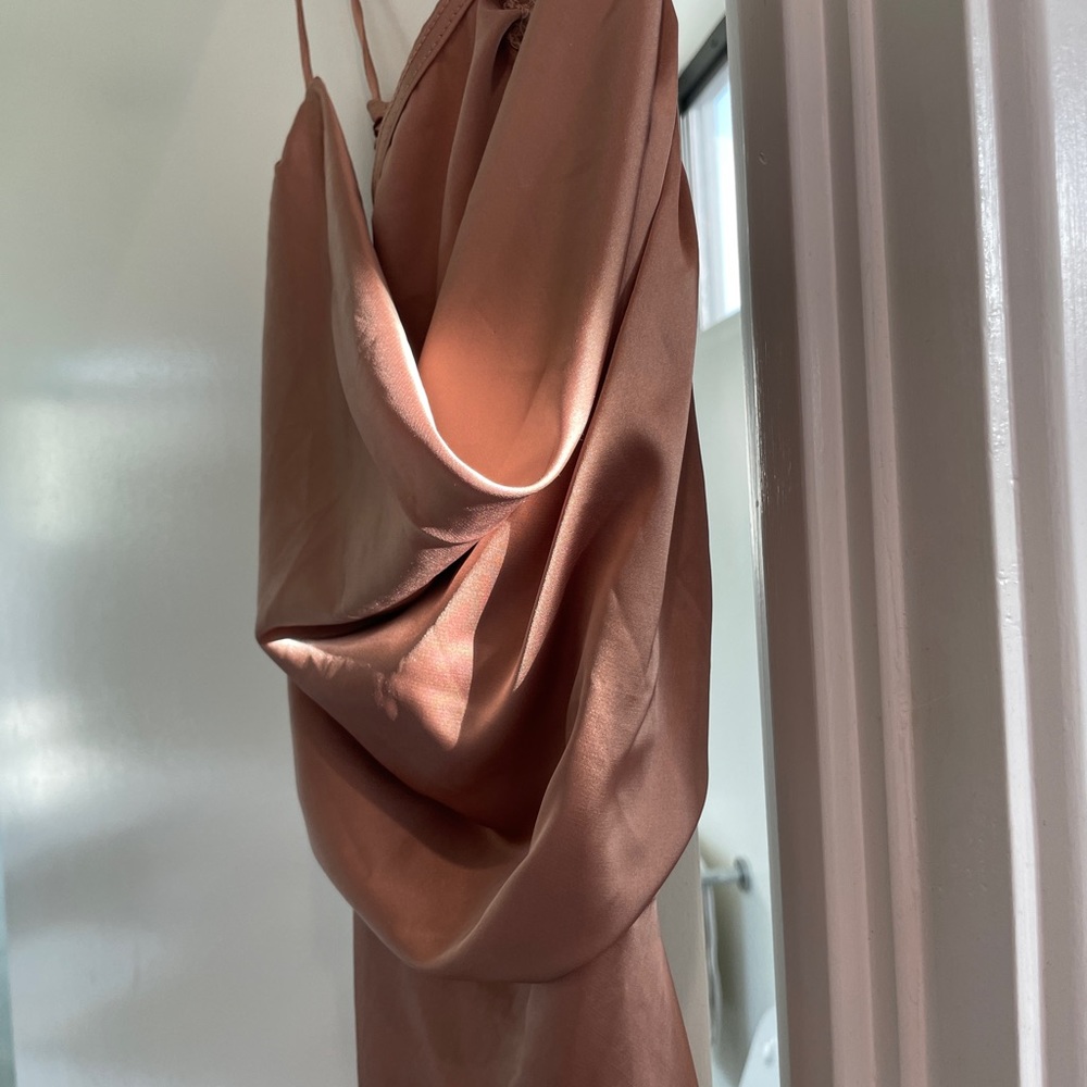 Silk dress is blush pink.